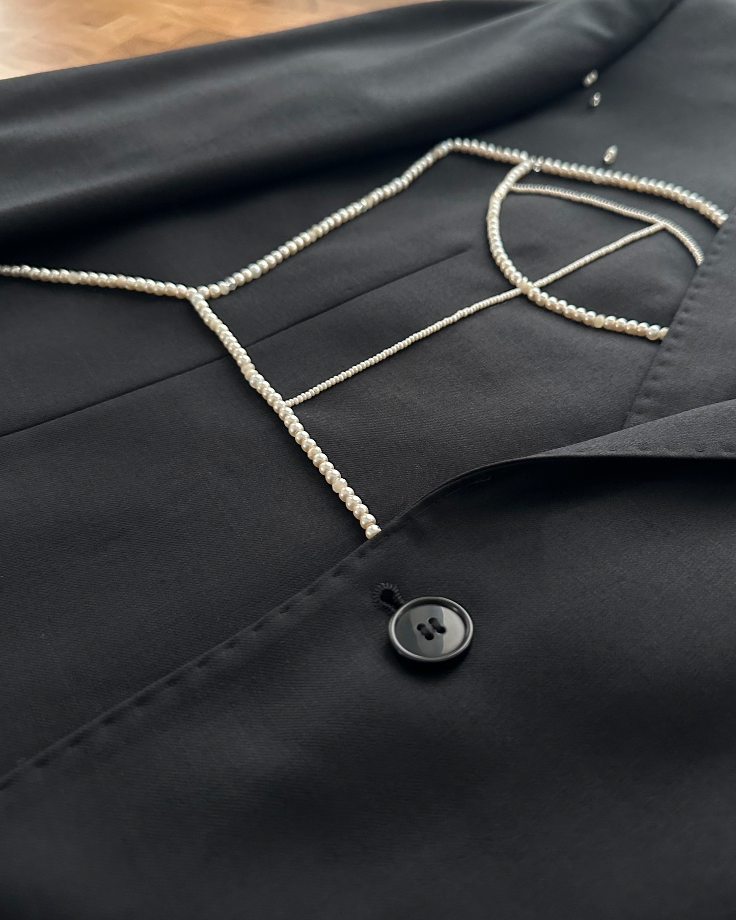 BLACK WOOL BLAZER WITH HAND-BEADED CORSET DESIGN